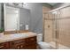 Bathroom with brown-toned tilework, an undermount sink, and a glass shower enclosure at 2500 S Monroe St, Denver, CO 80210