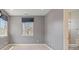 Bedroom features gray walls and carpeting and a view into the ensuite bathroom at 2500 S Monroe St, Denver, CO 80210