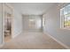 Bright bedroom boasts neutral walls, carpet, three windows letting in natural light, and an ensuite bathroom at 2500 S Monroe St, Denver, CO 80210