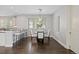 Dining area with modern light fixture, plantation shutters, seating for four, and dark, hardwood floors at 2500 S Monroe St, Denver, CO 80210