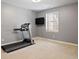 Home exercise room features a treadmill, wall-mounted television, and bright window at 2500 S Monroe St, Denver, CO 80210
