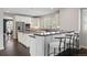 Spacious kitchen featuring a large island, modern appliances, and breakfast bar seating at 2500 S Monroe St, Denver, CO 80210