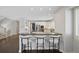 View of the eat-in kitchen showing the island, white cabinetry, countertops, and stainless steel appliances at 2500 S Monroe St, Denver, CO 80210