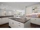 Spacious kitchen featuring a dark countertop island with gas cooktop and views into the open concept living space at 2500 S Monroe St, Denver, CO 80210