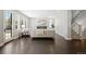 Open concept living room with fireplace, hardwood floors, neutral paint, and large windows at 2500 S Monroe St, Denver, CO 80210