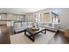 Living room with hardwood floors, neutral paint, large windows, and an open concept floor plan at 2500 S Monroe St, Denver, CO 80210