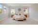 Serene bedroom with plush carpet, a comfortable bed, and large windows for natural light at 2500 S Monroe St, Denver, CO 80210