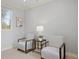 Cozy sitting room area featuring two chairs, a side table, and a large window at 2500 S Monroe St, Denver, CO 80210