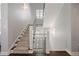 Elegant staircase with carpeted steps, decorative railing, and modern lighting at 2500 S Monroe St, Denver, CO 80210