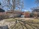 Large backyard with grass area, mature tree, brick garage and privacy fence at 3921 N Raleigh St, Denver, CO 80212