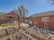 Spacious backyard with garden beds, mature tree, and access to a brick garage at 3921 N Raleigh St, Denver, CO 80212
