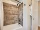 Shower over tub with decorative tile, shower curtain, and neutral walls at 3921 N Raleigh St, Denver, CO 80212