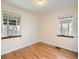Neutral bedroom with hardwood flooring, white walls, and sun-filled windows at 3921 N Raleigh St, Denver, CO 80212