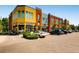 Vibrant commercial building with multiple storefronts, ample parking, and colorful facades at 3921 N Raleigh St, Denver, CO 80212