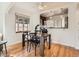 Well-lit dining room with hardwood floors and a view into the kitchen at 3921 N Raleigh St, Denver, CO 80212