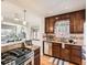 Modern kitchen with granite countertops, stainless appliances, and view into the living room at 3921 N Raleigh St, Denver, CO 80212
