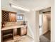 Basement kitchenette with countertop, cabinets, and view into laundry area at 3921 N Raleigh St, Denver, CO 80212