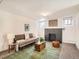 Finished basement living room with fireplace, neutral sofa, and decorative touches at 3921 N Raleigh St, Denver, CO 80212