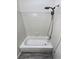 Simple bathroom with white bathtub and tiled walls at 2500 S Victor St # A, Aurora, CO 80014