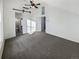 Main bedroom with grey carpet, barn door, and ceiling fan at 2500 S Victor St # A, Aurora, CO 80014