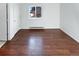 Bedroom with wood-look flooring and large window at 2500 S Victor St # A, Aurora, CO 80014