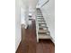 Bright hallway with hardwood floors and staircase at 2500 S Victor St # A, Aurora, CO 80014