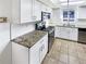 Modern kitchen with white cabinets, granite counters, and stainless steel appliances at 2500 S Victor St # A, Aurora, CO 80014