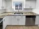 Modern kitchen with white cabinets, granite countertops and stainless steel appliances at 2500 S Victor St # A, Aurora, CO 80014