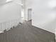 Loft bedroom with grey carpet and access to hallway at 2500 S Victor St # A, Aurora, CO 80014