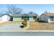 View of the home's front exterior with its well-maintained lawn, blue door, and updated siding at 104 Winnipeg St, Lochbuie, CO 80603