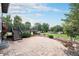 Backyard patio with lush landscaping and stairs to a deck above at 10731 E 151St Pl, Brighton, CO 80602