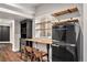 Finished basement bar area with modern appliances and wooden bar at 10731 E 151St Pl, Brighton, CO 80602