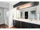 Bathroom featuring a double sink vanity, granite countertop, and glass shower at 10731 E 151St Pl, Brighton, CO 80602