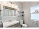 Bright bathroom featuring a modern vanity, shelves, and a well-lit mirror at 10731 E 151St Pl, Brighton, CO 80602