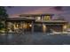 Beautiful two-story home boasting a three-car garage, covered porch, and landscaped front yard at sunset at 10731 E 151St Pl, Brighton, CO 80602