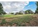 Spacious home featuring a large landscaped yard with mature trees and a white picket fence at 10731 E 151St Pl, Brighton, CO 80602
