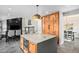 Modern kitchen features a large island with stone countertops, an oven, and built-in wooden refrigerator at 10731 E 151St Pl, Brighton, CO 80602