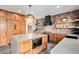 Gourmet kitchen featuring a large island, custom cabinets, brick backsplash, and modern appliances at 10731 E 151St Pl, Brighton, CO 80602
