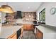 Well-appointed kitchen with custom cabinetry, a brick accent wall, and stainless-steel appliances, ideal for cooking at 10731 E 151St Pl, Brighton, CO 80602