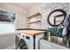 Modern laundry room with floating wood shelves, stainless sink and counterspace at 10731 E 151St Pl, Brighton, CO 80602