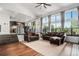 Bright living room with hardwood floors, large windows, and comfortable seating, showcasing modern design at 10731 E 151St Pl, Brighton, CO 80602