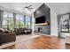 Inviting living room with a stone fireplace, large windows, hardwood floors, and comfortable seating at 10731 E 151St Pl, Brighton, CO 80602