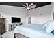 Comfortable main bedroom features a ceiling fan, plush carpet, and a tv at 10731 E 151St Pl, Brighton, CO 80602