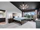 Spacious main bedroom with a dark vaulted ceiling, ceiling fan, and serene views at 10731 E 151St Pl, Brighton, CO 80602