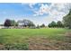 Expansive yard with beautiful landscaping and a charming home in the background at 10731 E 151St Pl, Brighton, CO 80602