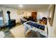 Finished basement boasting a foosball table, lounge area, and rustic stone accent wall at 20600 Rangeview Dr, Morrison, CO 80465