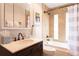 Cozy bathroom featuring shower-tub combo and modern fixtures at 20600 Rangeview Dr, Morrison, CO 80465