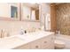 Bathroom showcasing double sinks with modern fixtures and a tiled shower-tub combination at 20600 Rangeview Dr, Morrison, CO 80465