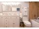 Bathroom featuring a dual vanity, a bathtub and shower with tile surround, and a modern commode at 20600 Rangeview Dr, Morrison, CO 80465
