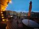 Outdoor deck lit up at night, offering scenic mountain views with seating and a fire pit at 20600 Rangeview Dr, Morrison, CO 80465